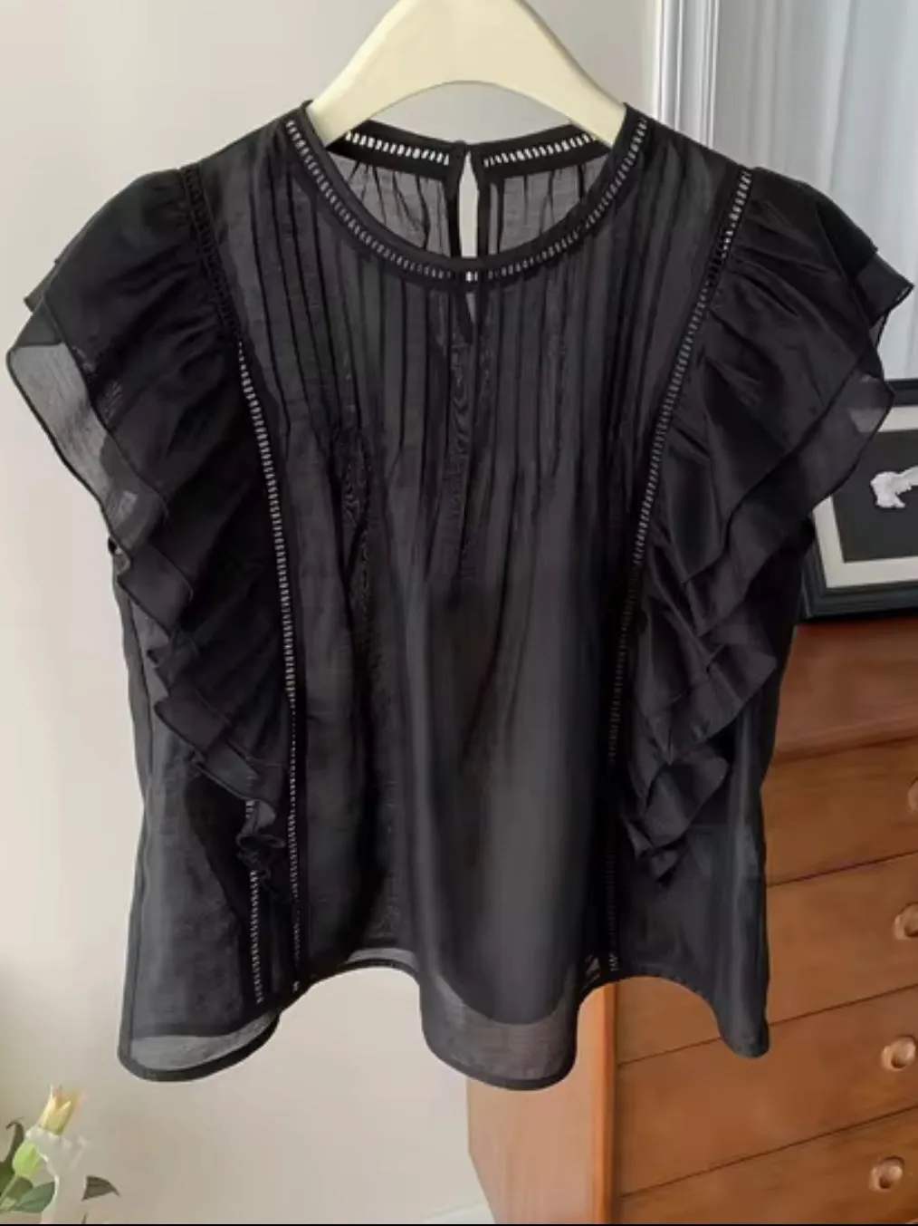 Black ruffled sleeveless top